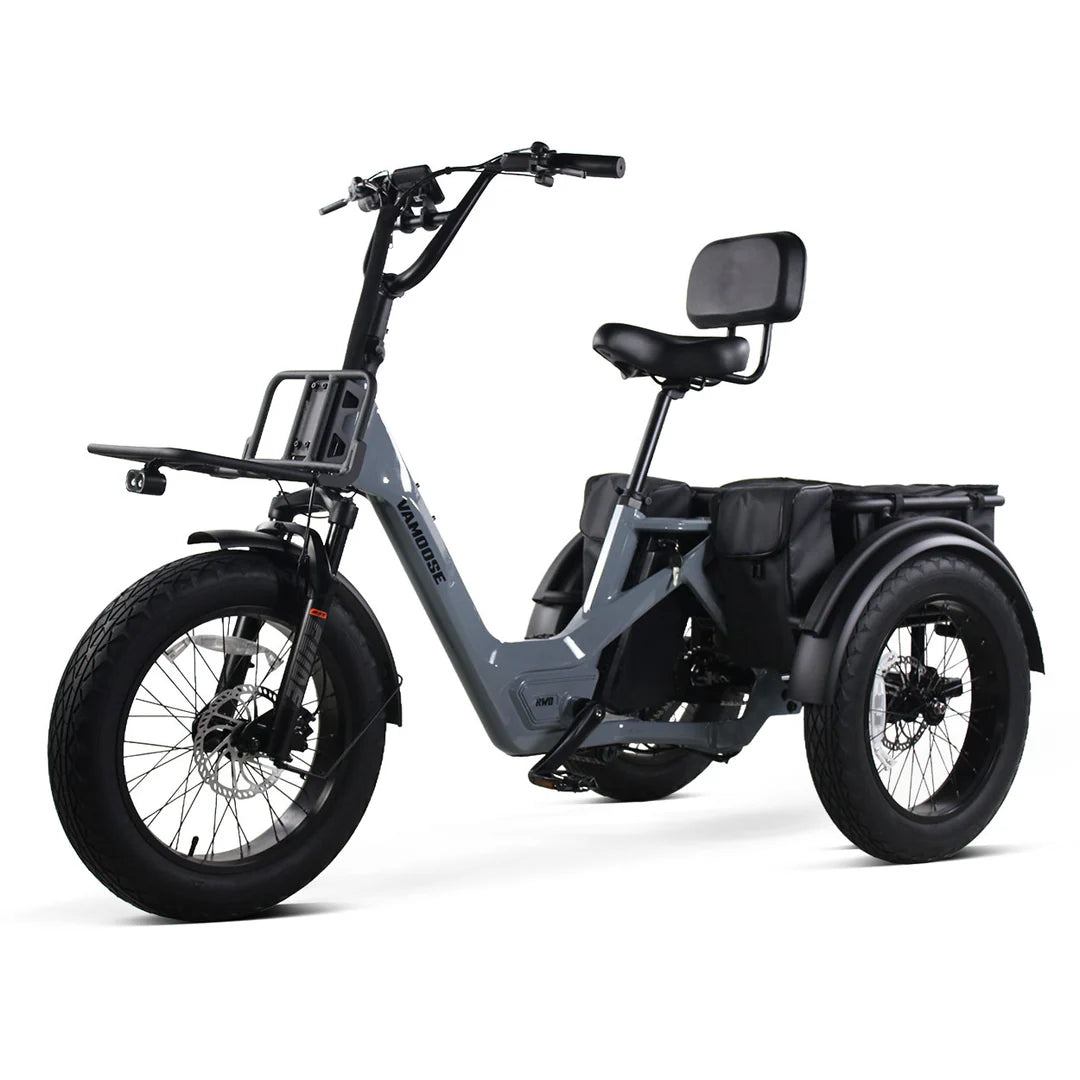 Vamoose Tri-Cycle SST electric trike with 52V 750W rear hub motor and rear differential for stability. Features 20"x4" fat tires, hydraulic disc brakes, comfortable plush seat, folding handlebar stem, and a large 52V 20Ah Samsung battery for extended range. Includes rear carrier bag, front shovel rack, and LED lights with signal indicator.