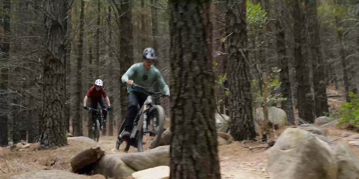 Two riders on Amflow PX e-MTBs in the forest