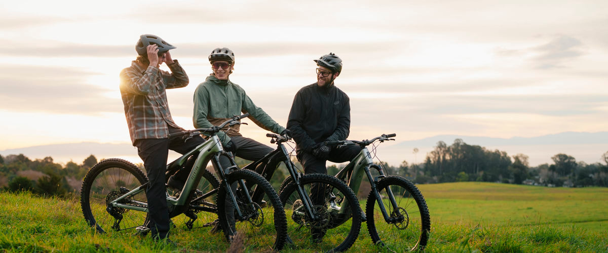 Three riders with Aventon Current eMTBs in an open field